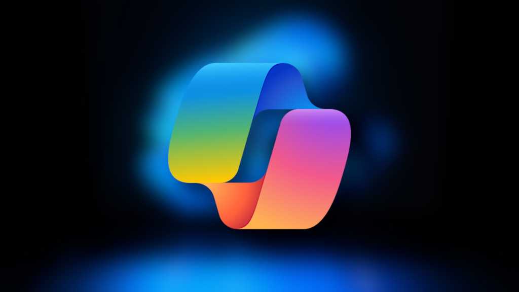 Microsoft Copilot logo on blurred Windows 11 laptop background